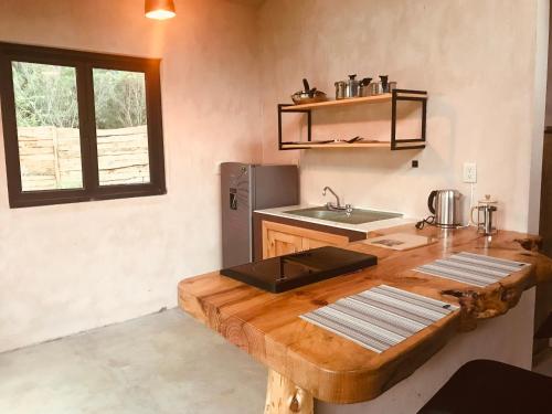a kitchen with a wooden table and a sink at Quinta Lum in San Cristóbal de Las Casas