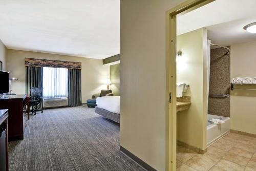 a hotel room with a bed and a desk at Hilton Garden Inn Conway in Conway