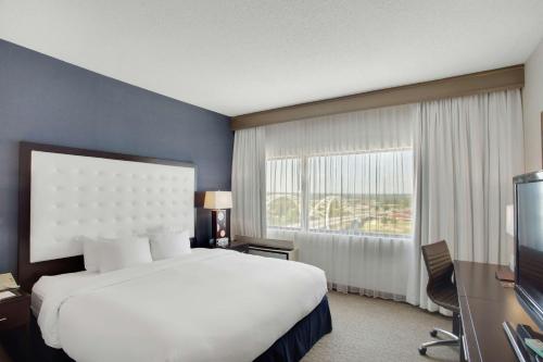 a hotel room with a bed and a large window at DoubleTree by Hilton Little Rock in Little Rock