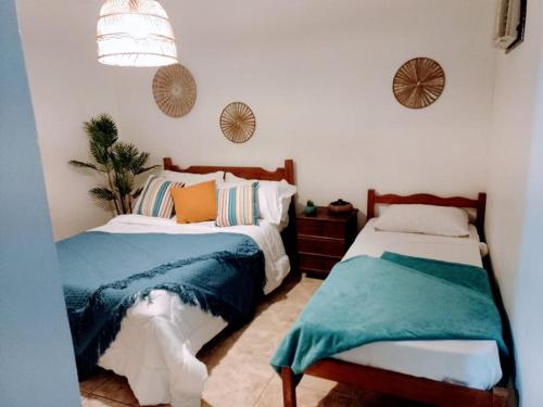 מיטה או מיטות בחדר ב-Hotel Pousada Recanto das Árvores