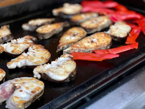 a bunch of food is cooking on a grill at CASUTELE VADULUI in Vadu