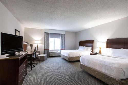 a hotel room with two beds and a flat screen tv at Hilton Garden Inn Lynchburg in Lynchburg