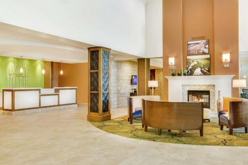 a lobby of a hotel with a fireplace at Hilton Garden Inn Manhattan Kansas in Manhattan