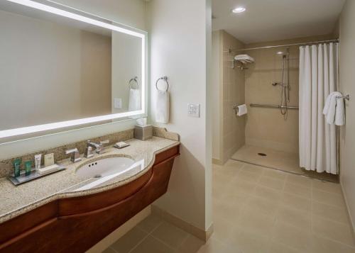 a bathroom with a sink and a shower at Hilton President Kansas City in Kansas City