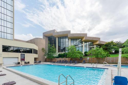 a swimming pool in front of a building at Hilton Memphis in Memphis