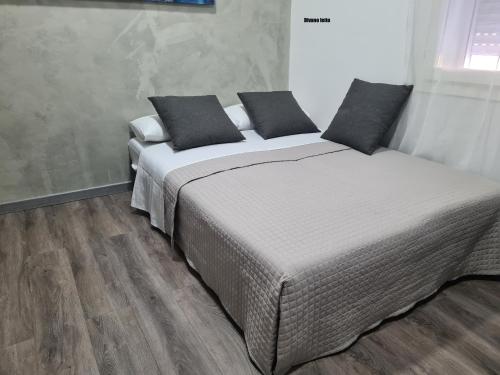 a bedroom with two beds and a wooden floor at Apartment Udine in Udine