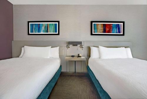 a hotel room with two beds and a table at Hilton Garden Inn Memphis/Southaven in Southhaven