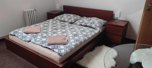 a bedroom with a bed and a glass table at U Certa in Čerčany
