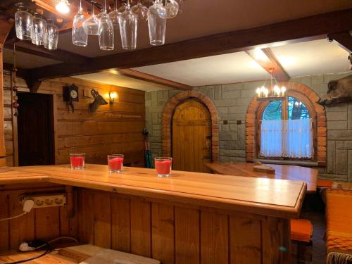 a bar in a room with glasses on top of it at "Jurkówka" in Szczyrk