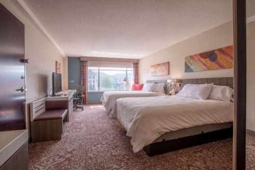 a hotel room with two beds and a television at Hilton Garden Inn Mankato Downtown in Mankato