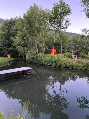 a picnic table sitting in the middle of a pond at Beko’s garden Inn in Mestia