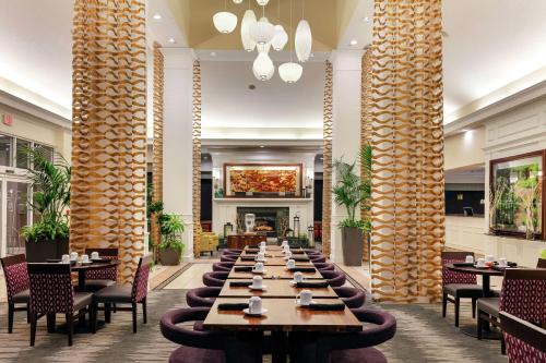 a long dining room with tables and chairs at Hilton Garden Inn Mobile West I-65 Airport Boulevard in Mobile
