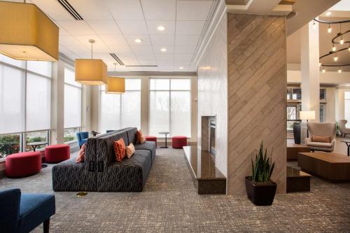 a lobby with a couch and chairs and a fireplace at Hilton Garden Inn Nashville Smyrna in Smyrna