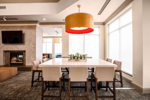 a dining room with a white table and chairs at Hilton Garden Inn Nashville Smyrna in Smyrna