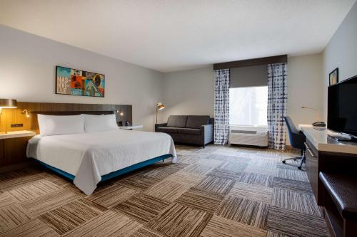 a hotel room with a bed and a television at Hilton Garden Inn Nashville Smyrna in Smyrna