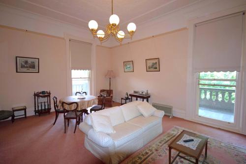 a living room with a white couch and a table at Kilmany Park Estate in Sale