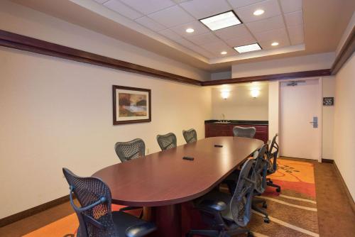 a conference room with a wooden table and chairs at Hilton Garden Inn Wisconsin Dells in Wisconsin Dells