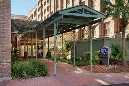 a building with a blue stop sign in front of it at Hampton Inn and Suites New Orleans Convention Center in New Orleans