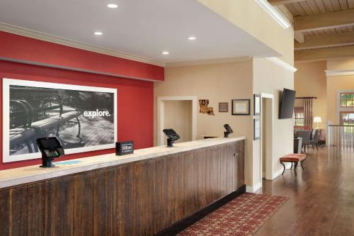 a hotel lobby with a waiting area with a large screen at Hampton Inn and Suites New Orleans Convention Center in New Orleans