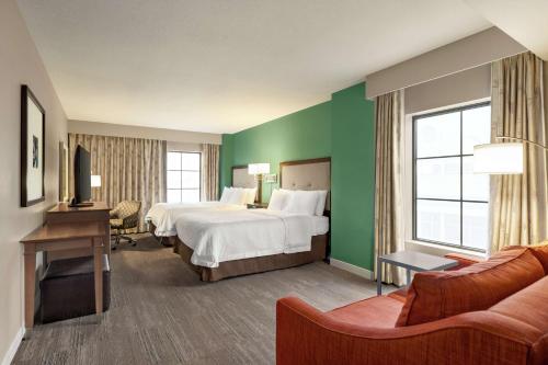 a hotel room with a large bed and green walls at Hampton Inn and Suites New Orleans Convention Center in New Orleans