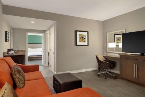 a living room with a couch and a desk at Hampton Inn and Suites New Orleans Convention Center in New Orleans