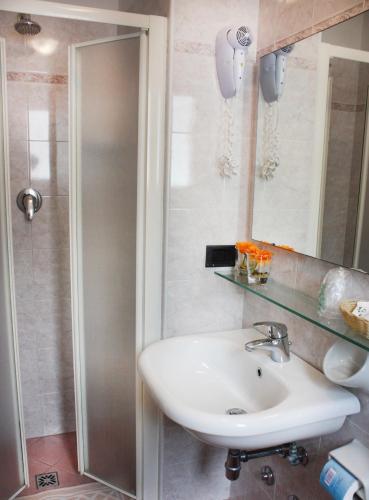 a bathroom with a sink and a shower at Hotel Daniela in Rimini