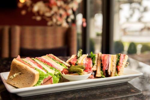 a plate of sandwiches and a bowl of broccoli at Hilton Chicago/Oak Lawn in Chicago