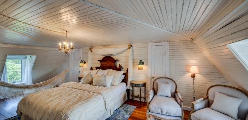 a bedroom with a large bed and two chairs at Fairytale Loft Suite 1 bed, 1 bath Luxury Apartment in Downtown Belmont in Charlottesville