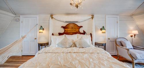 a bedroom with a large bed and a chandelier at Fairytale Loft Suite 1 bed, 1 bath Luxury Apartment in Downtown Belmont in Charlottesville