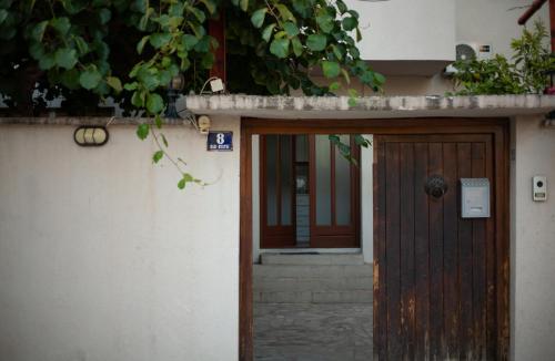 an entrance to a house with a wooden door at Apartments Azra in Mostar