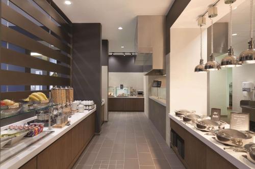 a large kitchen with a long counter in a restaurant at Embassy Suites Oklahoma City Downtown/Medical Center in Oklahoma City