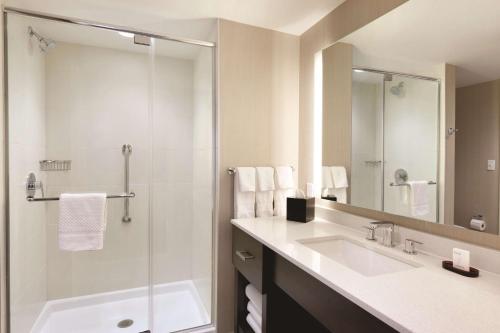 a bathroom with a sink and a shower at Embassy Suites Oklahoma City Downtown/Medical Center in Oklahoma City