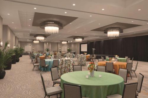 a banquet hall with tables and chairs and chandeliers at Embassy Suites Oklahoma City Downtown/Medical Center in Oklahoma City