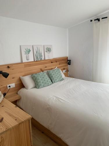 a bedroom with a large white bed with two pillows at Can Marasí in Lloret de Mar