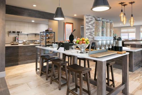 a kitchen with a large island with bar stools at Hilton Garden Inn Omaha West in Omaha