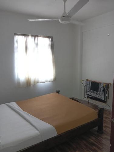 a bedroom with a large bed with a window at KHAIRUL HOMESTAY SEBERANG JAYA in Kampong Telok