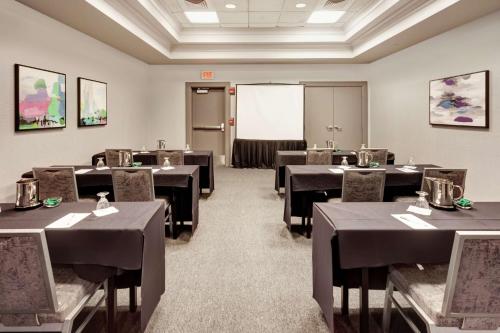 a conference room with tables and chairs and a whiteboard at Hilton Garden Inn Evanston in Evanston