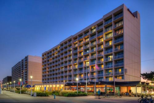 a large building with lights in front of it at Hampton Inn Virginia Beach-Oceanfront South in Virginia Beach