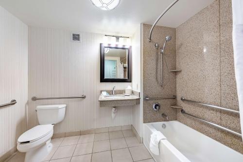a bathroom with a toilet and a tub and a sink at Hilton Garden Inn Oxnard/Camarillo in Oxnard