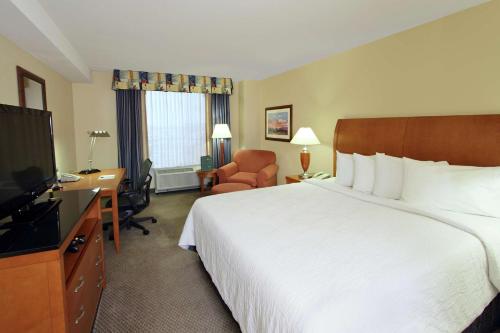 a hotel room with a large bed and a television at Hilton Garden Inn Oxnard/Camarillo in Oxnard