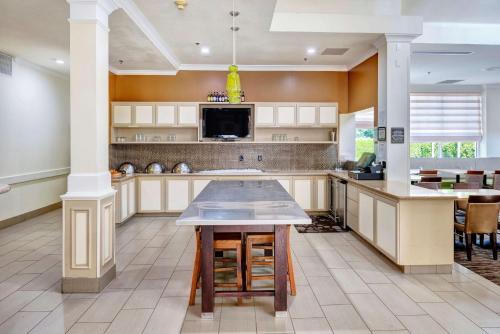 a large kitchen with a large island with a table at Hilton Garden Inn Portland Airport in Portland