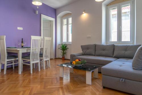 a living room with a couch and a table at Garden Apartment in Split