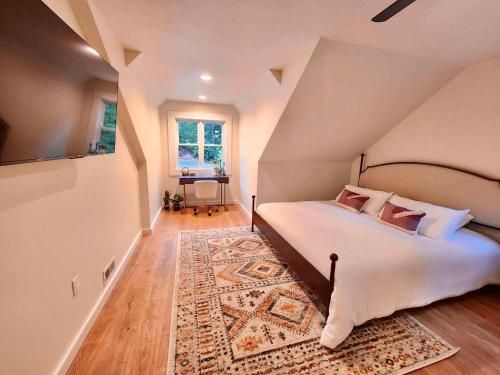 a bedroom with a large bed and a rug at Sliding Rock -A Creekside Cottage w7 acres, Waterfalls & Hiking in Old Fort