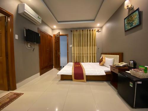 a bedroom with a bed and a desk in a room at Golden Hotel in Vung Tau