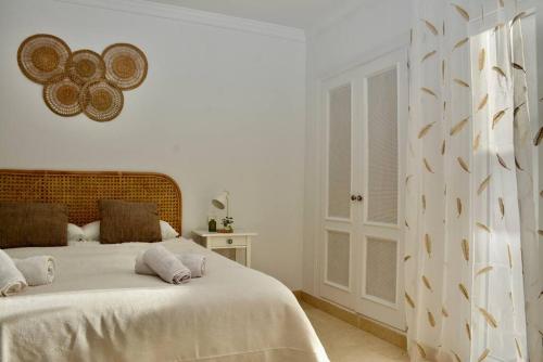 a white bedroom with a bed with white sheets at Golfer Paradise next to La Quinta Golf Club RDR319 in Benahavís