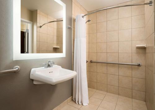 a bathroom with a sink and a shower at Hilton Clearwater Beach Resort & Spa in Clearwater Beach