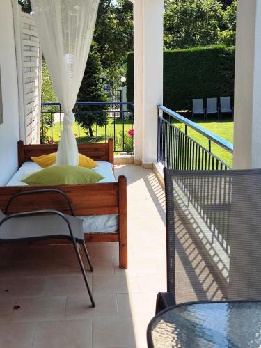 a porch with a bed and a table at Villa Riviera in Stavros