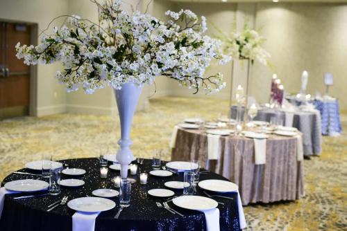 a table with a vase of flowers on top of it at DoubleTree By Hilton Baltimore North Pikesville in Pikesville