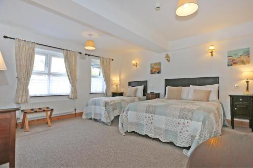 a bedroom with two beds and a table at The Courtyard Guesthouse B&B in Bunratty