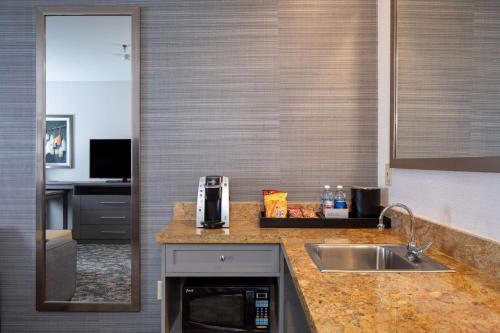 a kitchen with a sink and a counter top at Embassy Suites by Hilton Portland Maine in Portland